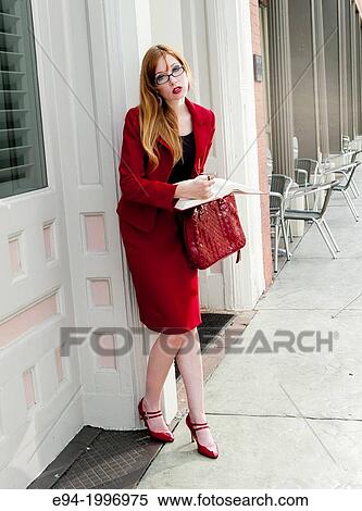 31 year old red headed woman in a business suit in an urban environment holding a law book. View Large Photo Image Stock Photography - 31 year old red headed woman in a business suit in an urban environment holding a law book.. Fotosearch