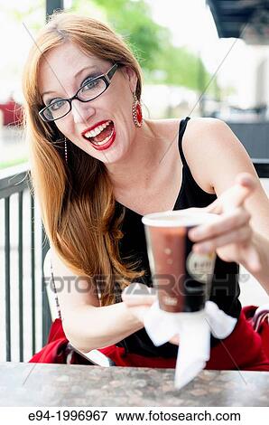 Stock Photo - 31 year old woman at an outdoor cafe.. Fotosearch