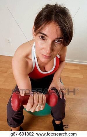 35 Year old female brunette exercises in her home. View Large Photo Image Stock Image - 35 Year old female brunette exercises in her home.. Fotosearch