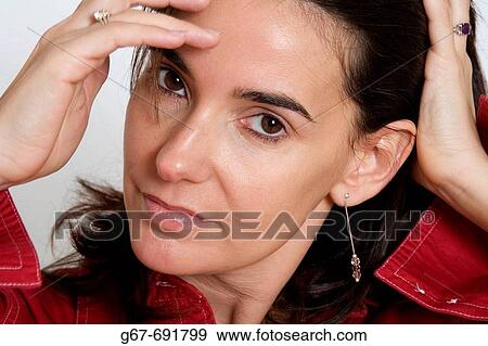 35 Year old female brunette looks into the camera as she poses for studio head shot portrait. View Large Photo Image Stock Photo - 35 Year old female brunette looks into the camera as she poses for studio head shot portrait.. Fotosearch