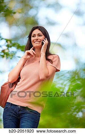 35 year old woman in park talking with smartphone. Donostia. San Sebastian. Gipuzkoa. Basque Country- Spain. View Large Photo Image Stock Image - 35 year old woman in park talking with smartphone. Donostia. San Sebastian. Gipuzkoa. Basque Country- Spain.. Fotosearch