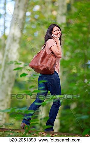 35 year old woman in park talking with smartphone. Donostia. San Sebastian. Gipuzkoa. Basque Country- Spain. View Large Photo Image Stock Photo - 35 year old woman in park talking with smartphone. Donostia. San Sebastian. Gipuzkoa. Basque Country- Spain.. Fotosearch