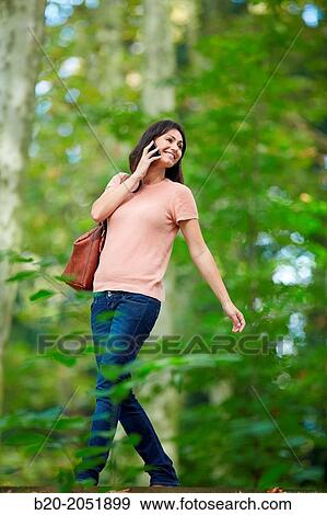 35 year old woman in park talking with smartphone. Donostia. San Sebastian. Gipuzkoa. Basque Country- Spain. View Large Photo Image Stock Photo - 35 year old woman in park talking with smartphone. Donostia. San Sebastian. Gipuzkoa. Basque Country- Spain.. Fotosearch
