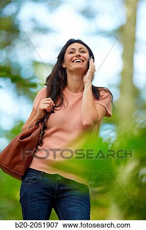 35 year old woman in park talking with smartphone. Donostia. San Sebastian. Gipuzkoa. Basque Country- Spain. View Large Photo Image Stock Photo - 35 year old woman in park talking with smartphone. Donostia. San Sebastian. Gipuzkoa. Basque Country- Spain.. Fotosearch