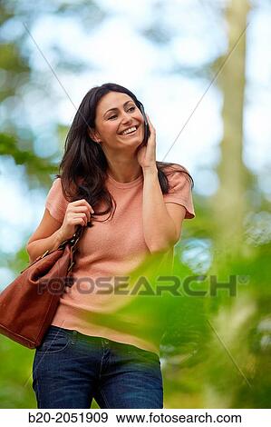 35 year old woman in park talking with smartphone. Donostia. San Sebastian. Gipuzkoa. Basque Country- Spain. View Large Photo Image Stock Photo - 35 year old woman in park talking with smartphone. Donostia. San Sebastian. Gipuzkoa. Basque Country- Spain.. Fotosearch