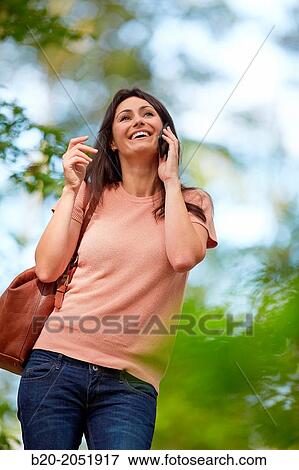 35 year old woman in park talking with smartphone. Donostia. San Sebastian. Gipuzkoa. Basque Country- Spain. View Large Photo Image Stock Photo - 35 year old woman in park talking with smartphone. Donostia. San Sebastian. Gipuzkoa. Basque Country- Spain.. Fotosearch