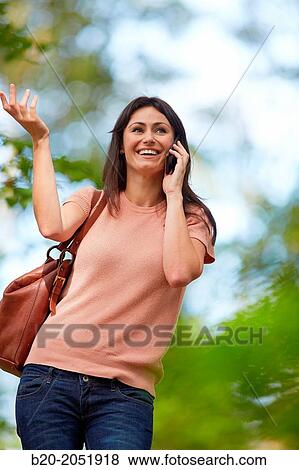 35 year old woman in park talking with smartphone. Donostia. San Sebastian. Gipuzkoa. Basque Country- Spain. View Large Photo Image Stock Photo - 35 year old woman in park talking with smartphone. Donostia. San Sebastian. Gipuzkoa. Basque Country- Spain.. Fotosearch