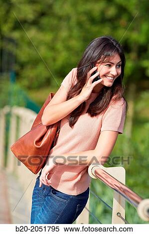 35 year old woman in park talking with smartphone. Donostia. San Sebastian. Gipuzkoa. Basque Country- Spain. View Large Photo Image Stock Photography - 35 year old woman in park talking with smartphone. Donostia. San Sebastian. Gipuzkoa. Basque Country- Spain.. Fotosearch