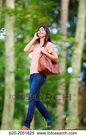 35 year old woman in park talking with smartphone. Donostia. San Sebastian. Gipuzkoa. Basque Country- Spain. View Large Photo Image Stock Photography - 35 year old woman in park talking with smartphone. Donostia. San Sebastian. Gipuzkoa. Basque Country- Spain.. Fotosearch