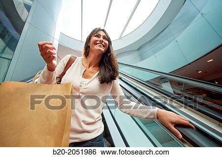 35 year old woman on escalators. Shopping at the Bretxa Market. Donostia. San Sebastian. Gipuzkoa. Basque Country. Spain. View Large Photo Image Stock Photograph - 35 year old woman on escalators. Shopping at the Bretxa Market. Donostia. San Sebastian. Gipuzkoa. Basque Country. Spain.. Fotosearch