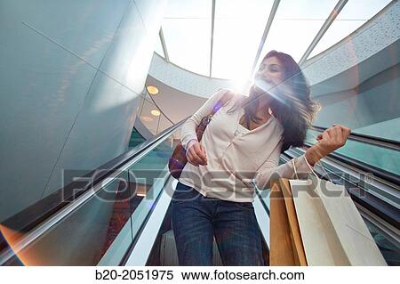 Stock Photography - 35 year old woman on escalators. Shopping at the Bretxa Market. Donostia. San Sebastian. Gipuzkoa. Basque Country. Spain.. Fotosearch