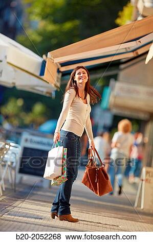 Stock Photo - 35 year old woman shopping on the street. Donostia. San Sebastian. Gipuzkoa. Basque Country. Spain.. Fotosearch