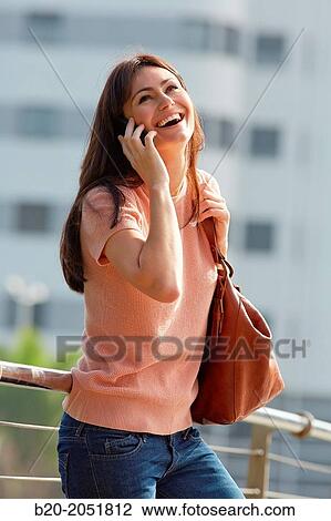 35 year old woman talking with smartphone in town. Donostia. San Sebastian. Gipuzkoa. Basque Country, Spain. View Large Photo Image Stock Image - 35 year old woman talking with smartphone in town. Donostia. San Sebastian. Gipuzkoa. Basque Country, Spain.. Fotosearch