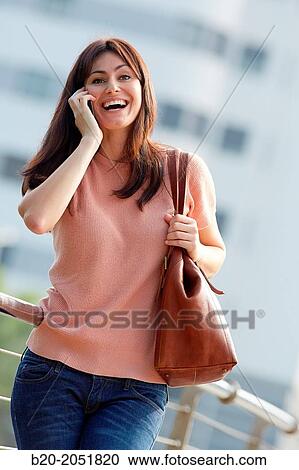35 year old woman talking with smartphone in town. Donostia. San Sebastian. Gipuzkoa. Basque Country, Spain. View Large Photo Image Stock Image - 35 year old woman talking with smartphone in town. Donostia. San Sebastian. Gipuzkoa. Basque Country, Spain.. Fotosearch