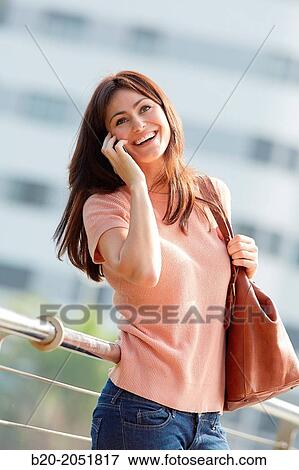 35 year old woman talking with smartphone in town. Donostia. San Sebastian. Gipuzkoa. Basque Country, Spain. View Large Photo Image Stock Photo - 35 year old woman talking with smartphone in town. Donostia. San Sebastian. Gipuzkoa. Basque Country, Spain.. Fotosearch