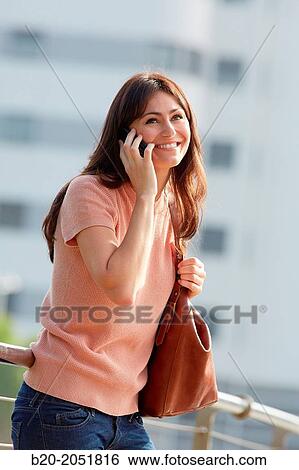 35 year old woman talking with smartphone in town. Donostia. San Sebastian. Gipuzkoa. Basque Country, Spain. View Large Photo Image Stock Photograph - 35 year old woman talking with smartphone in town. Donostia. San Sebastian. Gipuzkoa. Basque Country, Spain.. Fotosearch