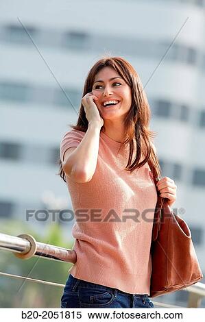 35 year old woman talking with smartphone in town. Donostia. San Sebastian. Gipuzkoa. Basque Country, Spain. View Large Photo Image Stock Photography - 35 year old woman talking with smartphone in town. Donostia. San Sebastian. Gipuzkoa. Basque Country, Spain.. Fotosearch
