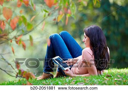 35 year old woman with digital tablet in park. Donostia. San Sebastian. Gipuzkoa. Basque Country, Spain. View Large Photo Image Stock Image - 35 year old woman with digital tablet in park. Donostia. San Sebastian. Gipuzkoa. Basque Country, Spain.. Fotosearch