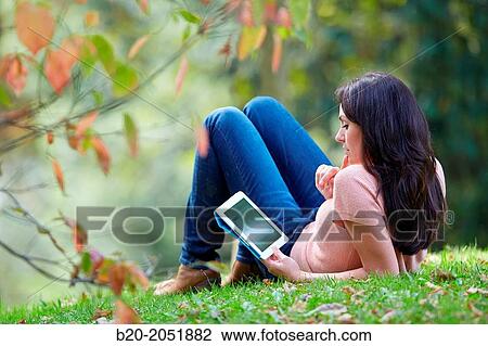 35 year old woman with digital tablet in park. Donostia. San Sebastian. Gipuzkoa. Basque Country, Spain. View Large Photo Image Stock Image - 35 year old woman with digital tablet in park. Donostia. San Sebastian. Gipuzkoa. Basque Country, Spain.. Fotosearch