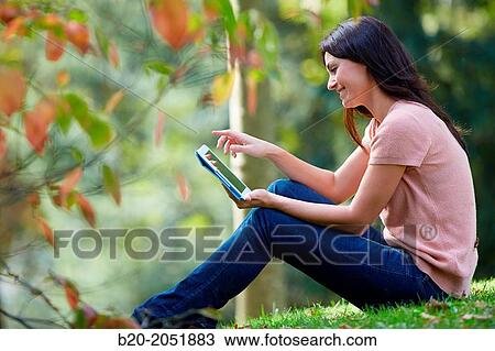 35 year old woman with digital tablet in park. Donostia. San Sebastian. Gipuzkoa. Basque Country, Spain. View Large Photo Image Stock Image - 35 year old woman with digital tablet in park. Donostia. San Sebastian. Gipuzkoa. Basque Country, Spain.. Fotosearch