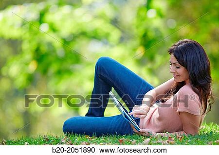 35 year old woman with digital tablet in park. Donostia. San Sebastian. Gipuzkoa. Basque Country, Spain. View Large Photo Image Stock Image - 35 year old woman with digital tablet in park. Donostia. San Sebastian. Gipuzkoa. Basque Country, Spain.. Fotosearch