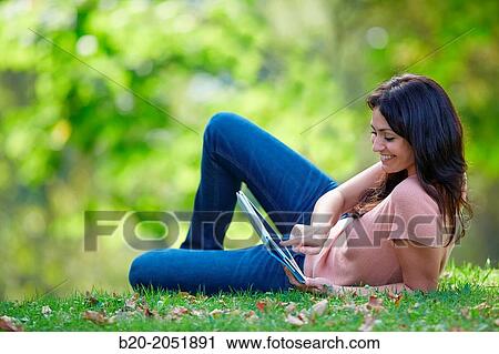 35 year old woman with digital tablet in park. Donostia. San Sebastian. Gipuzkoa. Basque Country, Spain. View Large Photo Image Stock Image - 35 year old woman with digital tablet in park. Donostia. San Sebastian. Gipuzkoa. Basque Country, Spain.. Fotosearch