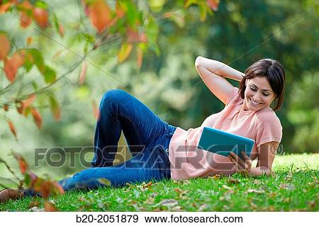 35 year old woman with digital tablet in park. Donostia. San Sebastian. Gipuzkoa. Basque Country, Spain. View Large Photo Image Stock Photo - 35 year old woman with digital tablet in park. Donostia. San Sebastian. Gipuzkoa. Basque Country, Spain.. Fotosearch