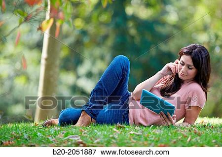 35 year old woman with digital tablet in park. Donostia. San Sebastian. Gipuzkoa. Basque Country, Spain. View Large Photo Image Stock Photo - 35 year old woman with digital tablet in park. Donostia. San Sebastian. Gipuzkoa. Basque Country, Spain.. Fotosearch