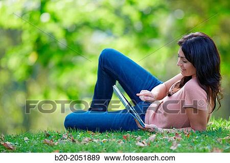 35 year old woman with digital tablet in park. Donostia. San Sebastian. Gipuzkoa. Basque Country, Spain. View Large Photo Image Stock Photo - 35 year old woman with digital tablet in park. Donostia. San Sebastian. Gipuzkoa. Basque Country, Spain.. Fotosearch