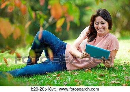 35 year old woman with digital tablet in park. Donostia. San Sebastian. Gipuzkoa. Basque Country, Spain. View Large Photo Image Stock Photography - 35 year old woman with digital tablet in park. Donostia. San Sebastian. Gipuzkoa. Basque Country, Spain.. Fotosearch