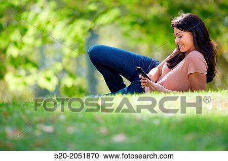 35 year old woman with smartphone in park. Donostia. San Sebastian. Gipuzkoa. Basque Country, Spain. View Large Photo Image Stock Image - 35 year old woman with smartphone in park. Donostia. San Sebastian. Gipuzkoa. Basque Country, Spain.. Fotosearch