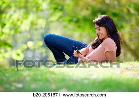 35 year old woman with smartphone in park. Donostia. San Sebastian. Gipuzkoa. Basque Country, Spain. View Large Photo Image Stock Image - 35 year old woman with smartphone in park. Donostia. San Sebastian. Gipuzkoa. Basque Country, Spain.. Fotosearch