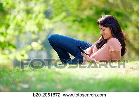 35 year old woman with smartphone in park. Donostia. San Sebastian. Gipuzkoa. Basque Country, Spain. View Large Photo Image Stock Image - 35 year old woman with smartphone in park. Donostia. San Sebastian. Gipuzkoa. Basque Country, Spain.. Fotosearch