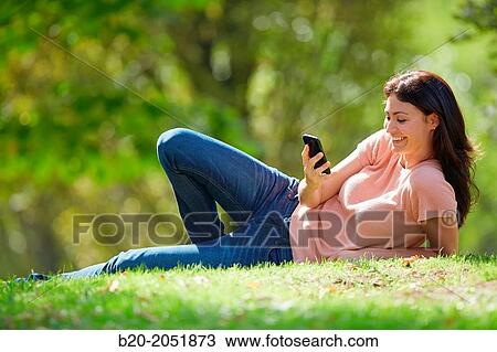 35 year old woman with smartphone in park. Donostia. San Sebastian. Gipuzkoa. Basque Country, Spain. View Large Photo Image Stock Image - 35 year old woman with smartphone in park. Donostia. San Sebastian. Gipuzkoa. Basque Country, Spain.. Fotosearch