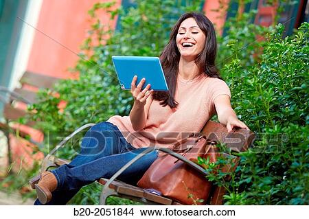 35 year old woman with tablet in a park. Donostia. San Sebastian. Gipuzkoa. Basque Country, Spain. View Large Photo Image Picture - 35 year old woman with tablet in a park. Donostia. San Sebastian. Gipuzkoa. Basque Country, Spain.. Fotosearch