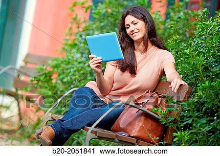 35 year old woman with tablet in a park. Donostia. San Sebastian. Gipuzkoa. Basque Country, Spain. View Large Photo Image Stock Image - 35 year old woman with tablet in a park. Donostia. San Sebastian. Gipuzkoa. Basque Country, Spain.. Fotosearch