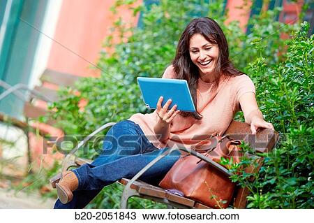 35 year old woman with tablet in a park. Donostia. San Sebastian. Gipuzkoa. Basque Country, Spain. View Large Photo Image Stock Image - 35 year old woman with tablet in a park. Donostia. San Sebastian. Gipuzkoa. Basque Country, Spain.. Fotosearch