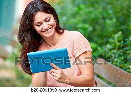 35 year old woman with tablet in a park. Donostia. San Sebastian. Gipuzkoa. Basque Country, Spain. View Large Photo Image Stock Image - 35 year old woman with tablet in a park. Donostia. San Sebastian. Gipuzkoa. Basque Country, Spain.. Fotosearch