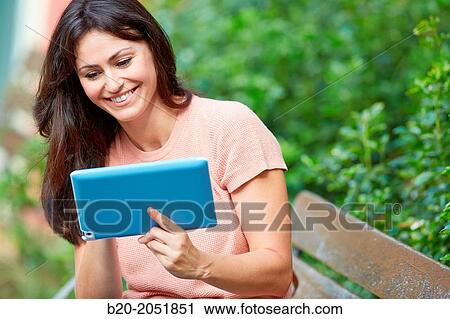 35 year old woman with tablet in a park. Donostia. San Sebastian. Gipuzkoa. Basque Country, Spain. View Large Photo Image Stock Image - 35 year old woman with tablet in a park. Donostia. San Sebastian. Gipuzkoa. Basque Country, Spain.. Fotosearch