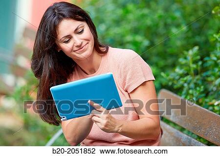 35 year old woman with tablet in a park. Donostia. San Sebastian. Gipuzkoa. Basque Country, Spain. View Large Photo Image Stock Image - 35 year old woman with tablet in a park. Donostia. San Sebastian. Gipuzkoa. Basque Country, Spain.. Fotosearch