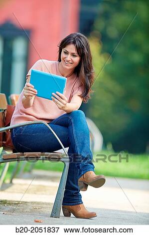 35 year old woman with tablet in a park. Donostia. San Sebastian. Gipuzkoa. Basque Country, Spain. View Large Photo Image Stock Photo - 35 year old woman with tablet in a park. Donostia. San Sebastian. Gipuzkoa. Basque Country, Spain.. Fotosearch