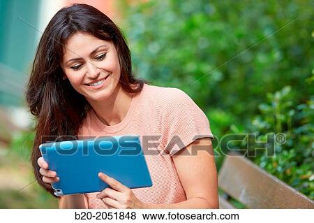 35 year old woman with tablet in a park. Donostia. San Sebastian. Gipuzkoa. Basque Country, Spain. View Large Photo Image Stock Photo - 35 year old woman with tablet in a park. Donostia. San Sebastian. Gipuzkoa. Basque Country, Spain.. Fotosearch
