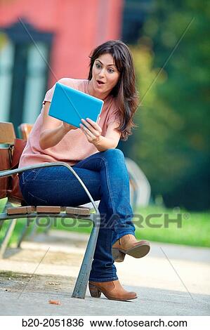 35 year old woman with tablet in a park. Donostia. San Sebastian. Gipuzkoa. Basque Country, Spain. View Large Photo Image Stock Photograph - 35 year old woman with tablet in a park. Donostia. San Sebastian. Gipuzkoa. Basque Country, Spain.. Fotosearch
