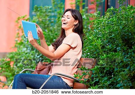 35 year old woman with tablet in a park. Donostia. San Sebastian. Gipuzkoa. Basque Country, Spain. View Large Photo Image Stock Photograph - 35 year old woman with tablet in a park. Donostia. San Sebastian. Gipuzkoa. Basque Country, Spain.. Fotosearch