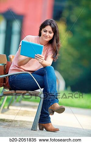 35 year old woman with tablet in a park. Donostia. San Sebastian. Gipuzkoa. Basque Country, Spain. View Large Photo Image Stock Photography - 35 year old woman with tablet in a park. Donostia. San Sebastian. Gipuzkoa. Basque Country, Spain.. Fotosearch