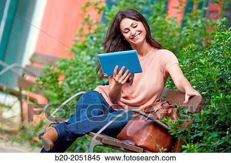35 year old woman with tablet in a park. Donostia. San Sebastian. Gipuzkoa. Basque Country, Spain. View Large Photo Image Stock Photography - 35 year old woman with tablet in a park. Donostia. San Sebastian. Gipuzkoa. Basque Country, Spain.. Fotosearch