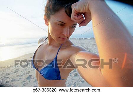 35 years old woman flexes muscles on the beach. Santa Monica. California. USA. View Large Photo Image Stock Image - 35 years old woman flexes muscles on the beach. Santa Monica. California. USA.. Fotosearch