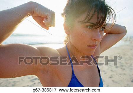 35 years old woman flexes muscles on the beach. Santa Monica. California. USA. View Large Photo Image Stock Photo - 35 years old woman flexes muscles on the beach. Santa Monica. California. USA.. Fotosearch
