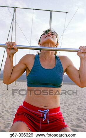 35 years old woman flexes muscles on the beach. Santa Monica. California. USA. View Large Photo Image Stock Photograph - 35 years old woman flexes muscles on the beach. Santa Monica. California. USA.. Fotosearch