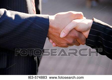 35 yr old business man shaking hands with 25 yr old caucasian business woman View Large Photo Image Stock Image - 35 yr old business man shaking hands with 25 yr old caucasian business woman. Fotosearch
